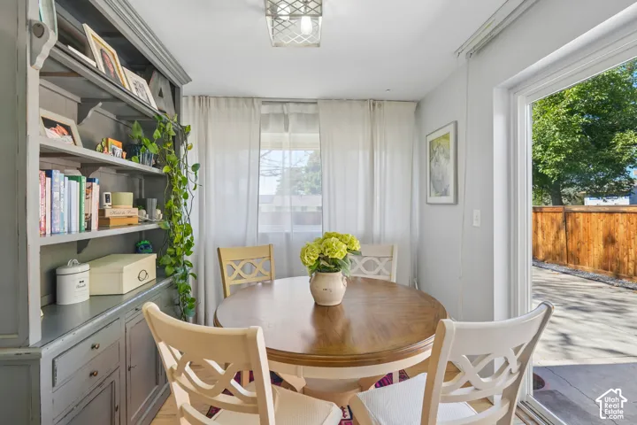 Built-in shelving with cabinetry, wood-finish flooring, and a sliding glass door
