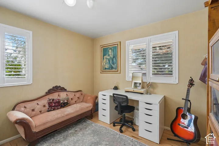 Recessed lighting illuminates wood-finish flooring