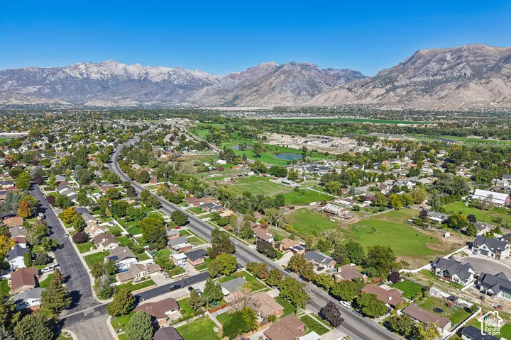 Expansive residential area featuring established homes, mature trees, and mountainous terrain