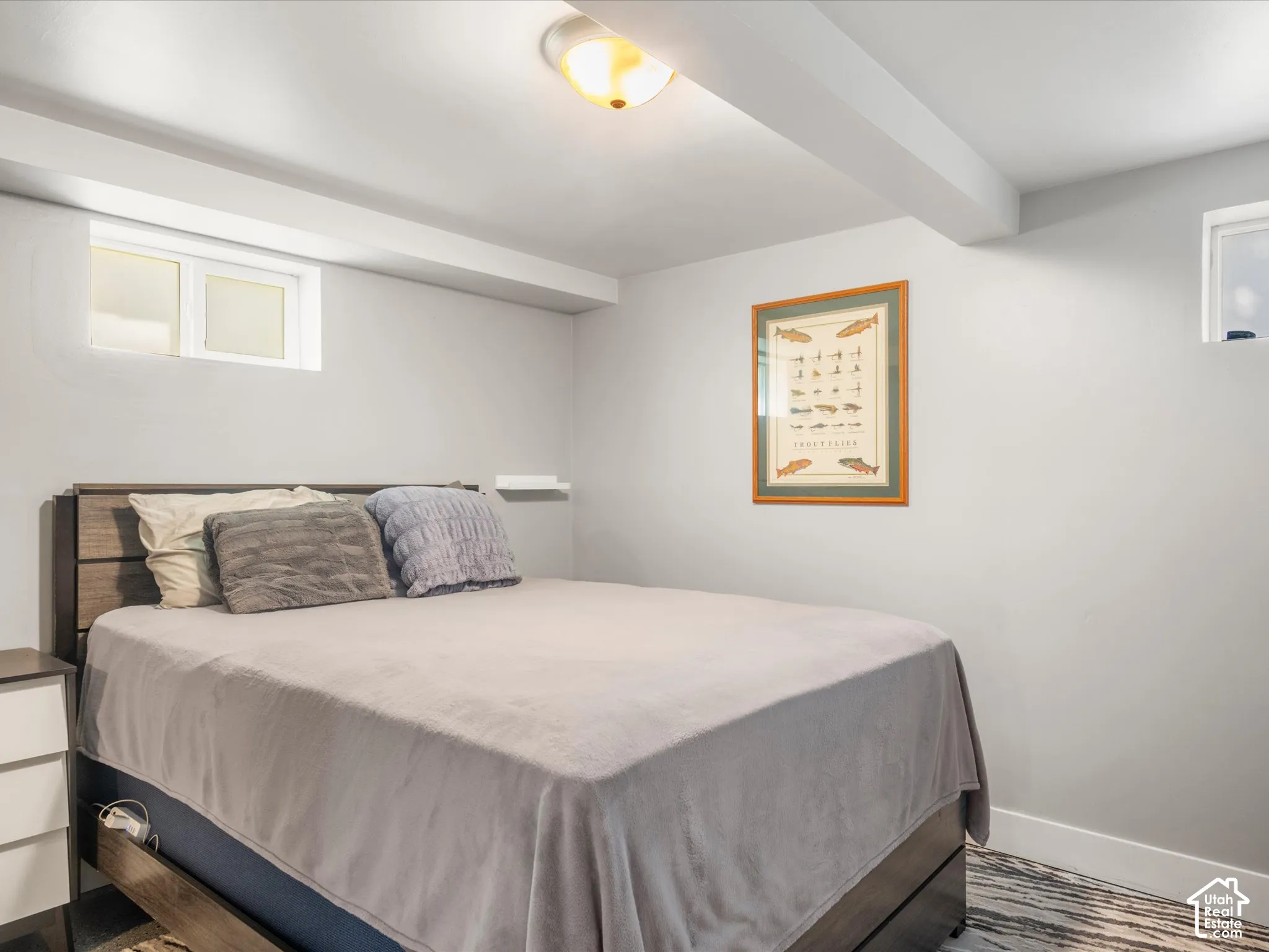 Recessed windows, ceiling-mounted light fixture, light gray wall paint, and white ceiling beams