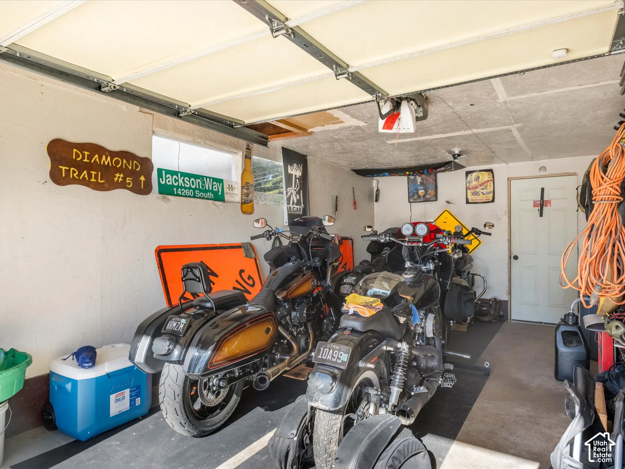 Garage space featuring an overhead door track system, a window, and an interior door