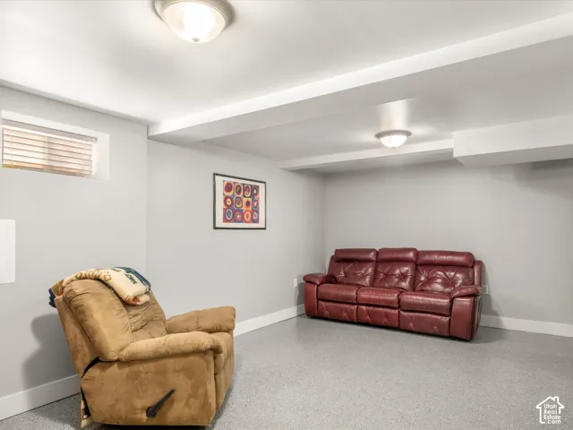 Light grey walls with white trim, flush-mount ceiling lights, and a small transom window with blinds