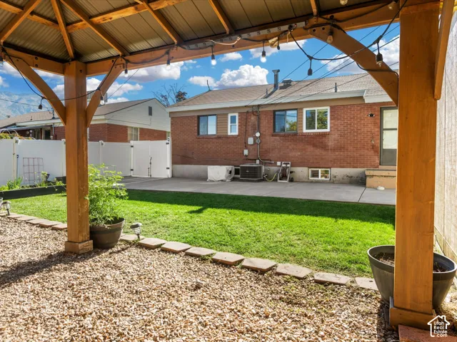Wooden pergola with string lighting and corrugated metal roof