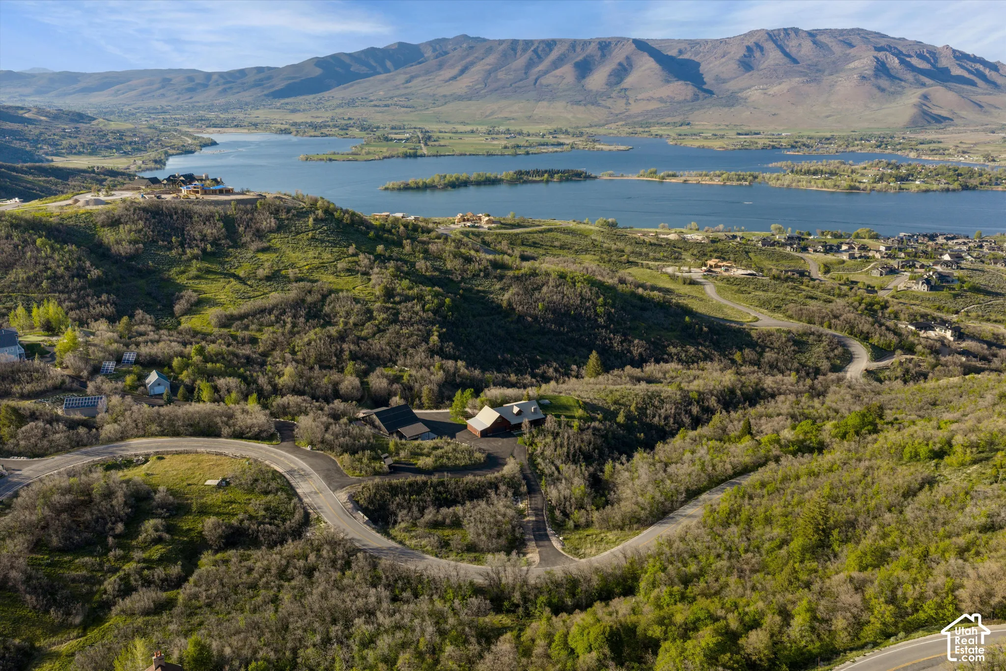 Expansive mountain scenery with a prominent lake and surrounding hills