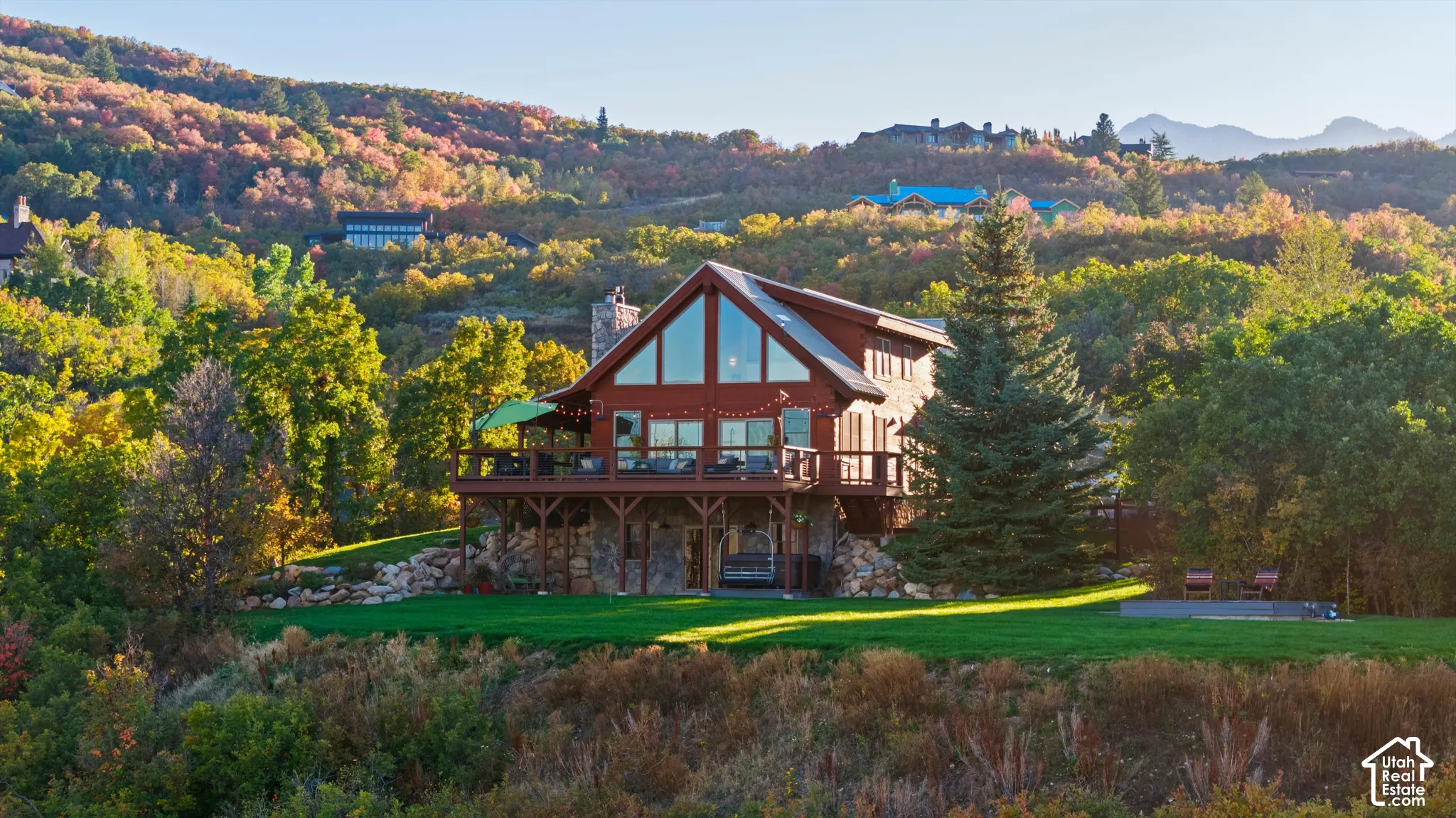 Wood-sided residence featuring a stone foundation and a prominent A-frame window design