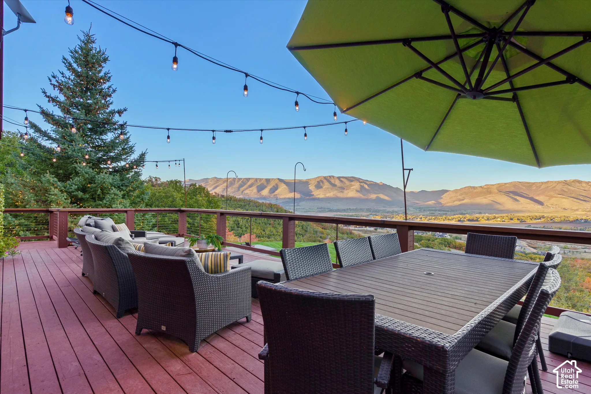 Expansive outdoor deck featuring composite decking, string lights, and a railing system