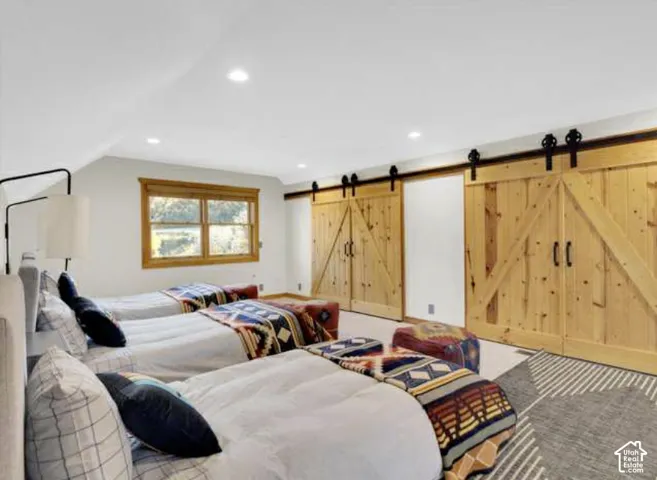 Recessed lighting, wood-frame window, barn-door style closet doors, wood-finish flooring