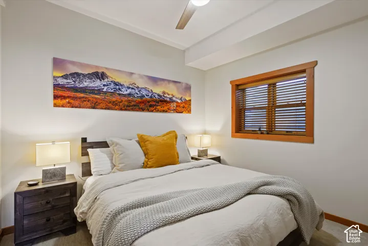 Wood-finish flooring, wood window trim, and a ceiling fan