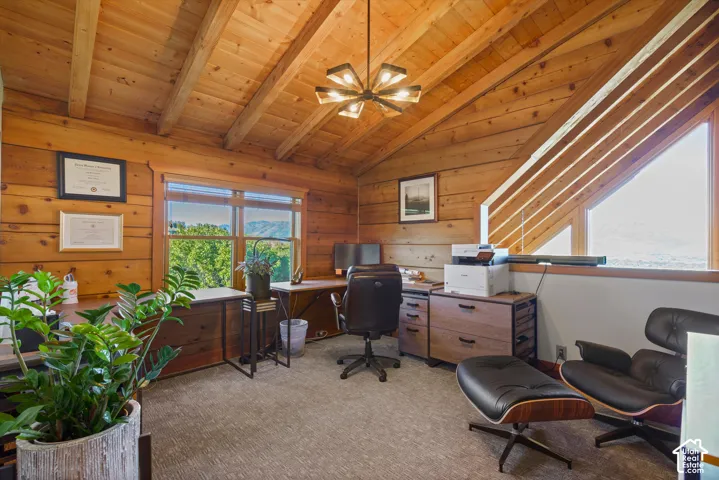 Vaulted wood-paneled ceiling with exposed beams, wood-plank walls, and a modern chandelier
