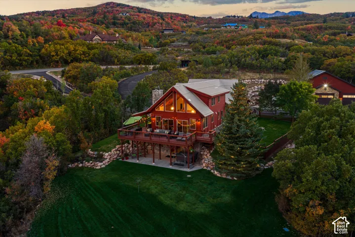 Red exterior with an expansive wooden deck, large windows, and a prominent A-frame architectural style