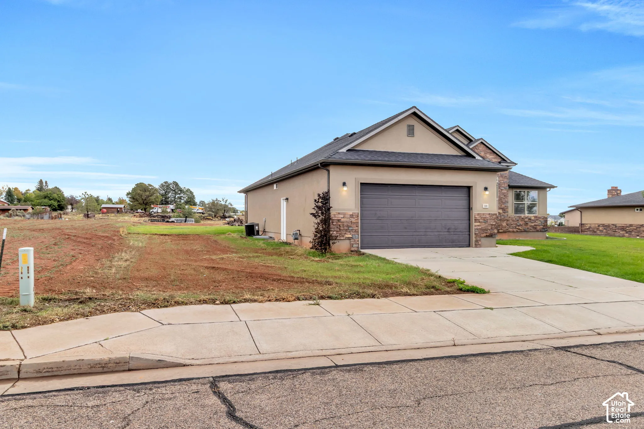 Attached garage with a paved driveway