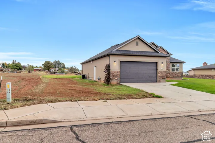 Attached garage with a paved driveway