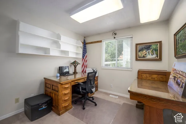 Built-in shelving, natural light from a window, and overhead flush-mount lighting fixtures