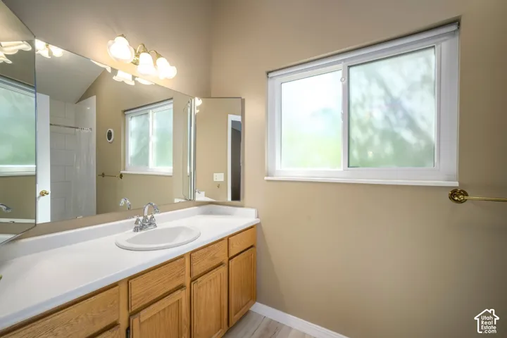Wood-finish flooring, light-toned walls, and a white framed window