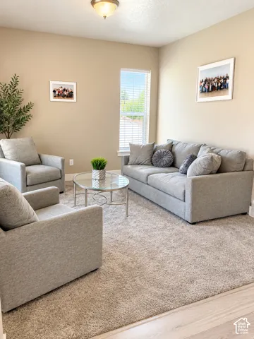 Recessed lighting, neutral wall paint, and a window with horizontal blinds