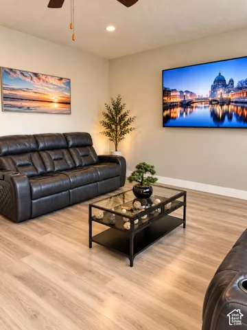 Recessed ceiling lighting, wood-finish flooring, and a ceiling fan