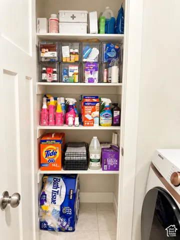 Built-in shelving unit with multiple shelves and light-colored tile flooring