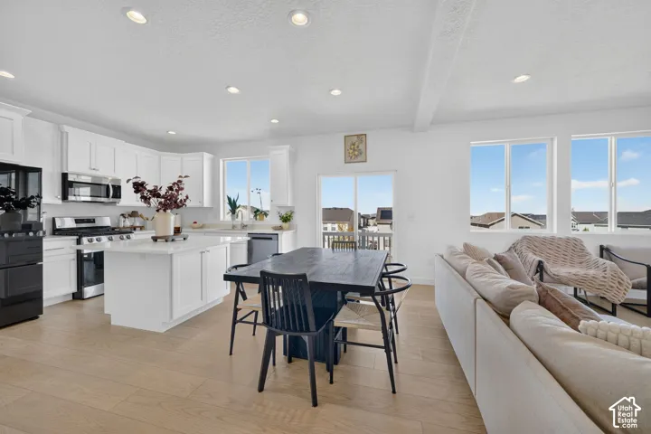 Open-concept living space featuring wood-finish flooring