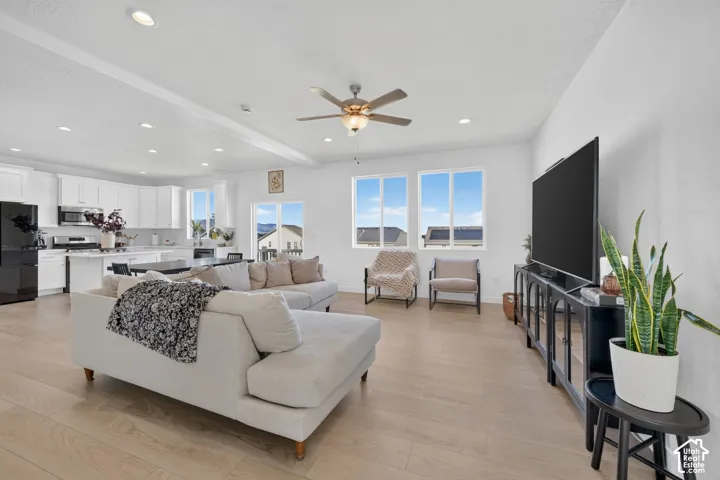 Expansive open-concept living area featuring light wood-finish flooring