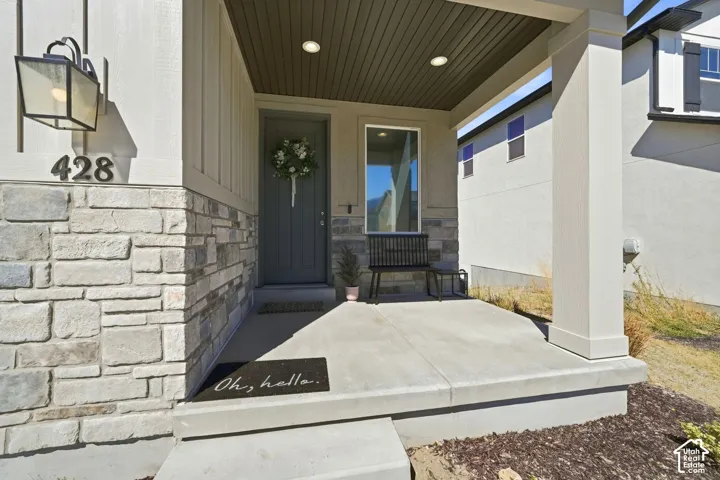 Covered porch with stone accents and board and batten siding