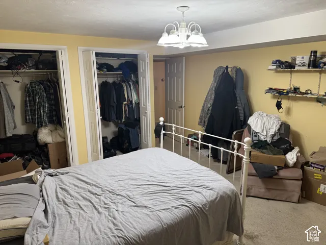 Recessed lighting, two bi-fold door closets, and a ceiling-mounted chandelier