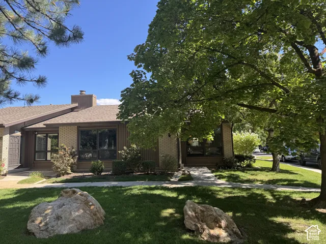 Brick and wood-sided exterior with a brown shingled roof