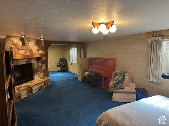 Stone-clad fireplace with a wood mantel