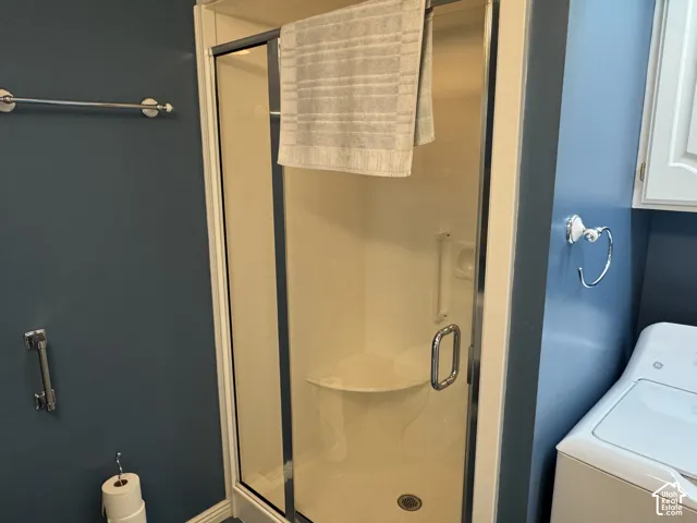 Walk-in shower with clear glass enclosure and built-in seating