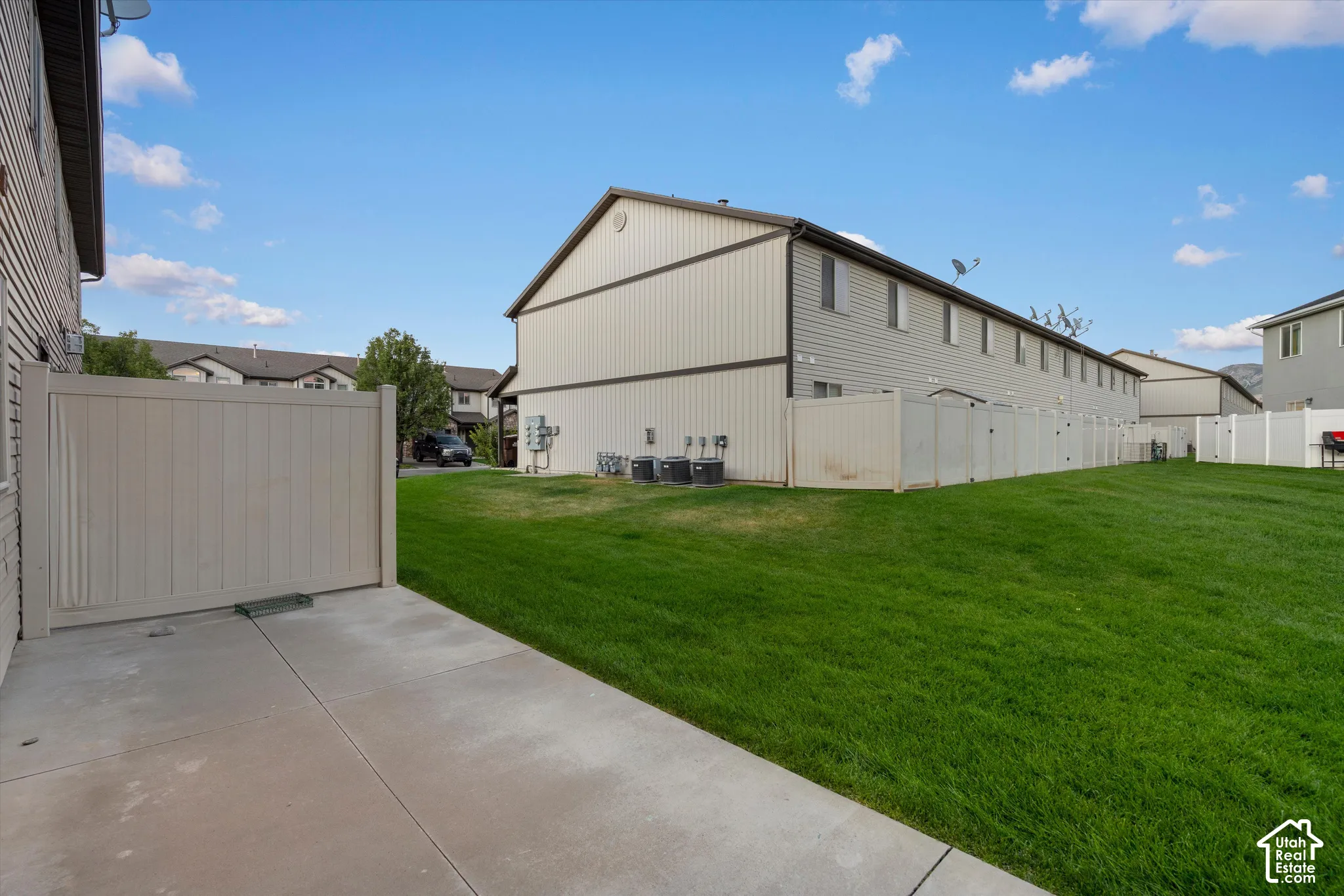 View from back patio with rare open view of common grass area instead of back neighbors