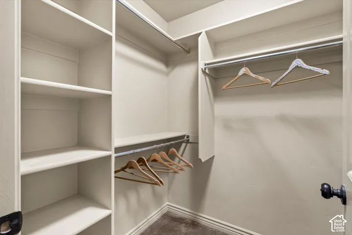 Walk-in closet in Primary featuring built-in shelving