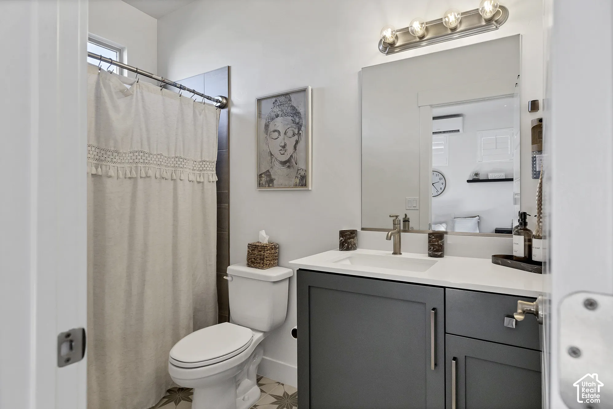 Casita bathroom featuring modern vanity with a gray cabinet, white countertop, and integrated sink
