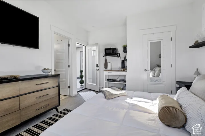 Casita with white walls with modern trim detail, built-in shelving, and a glass-paneled exterior door