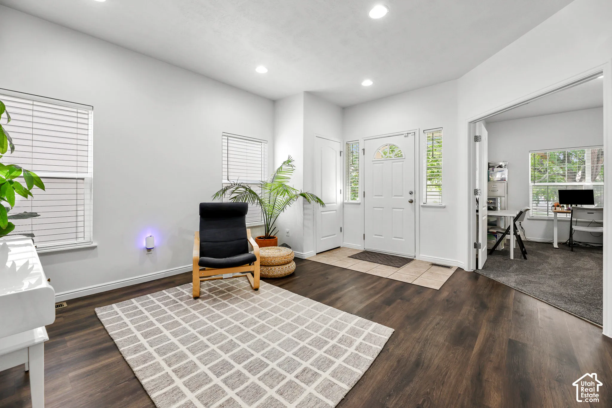 White walls, recessed lighting, wood-finish flooring, and white trim