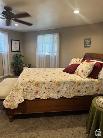 Wood-finish ceiling fan with integrated lighting, recessed ceiling light, and wall-to-wall carpeting