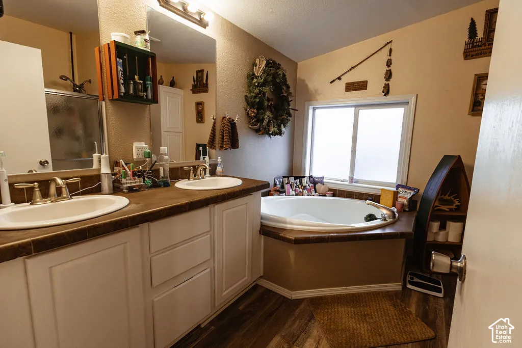 Dual vanity with undermount sinks, white cabinetry, and a textured countertop