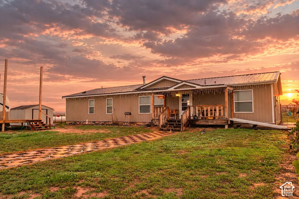 Single-story residence featuring a covered front porch, metal roof, and durable siding
