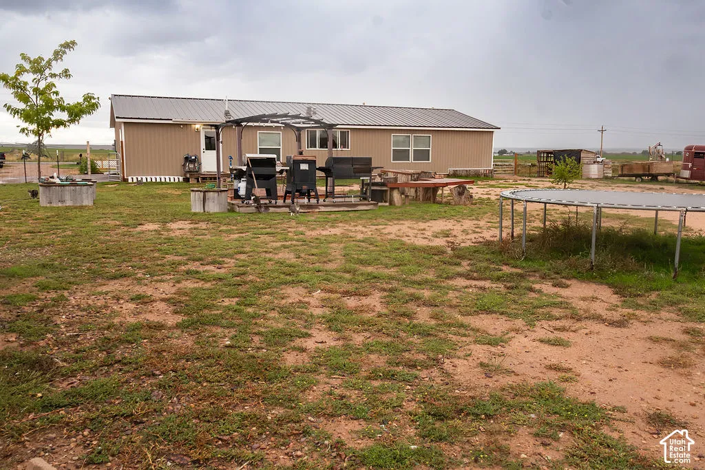 Single-story residence with a metal roof and tan siding