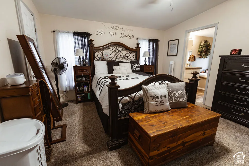 Carpeted room featuring a ceiling fan, window with curtain rods, and an interior door