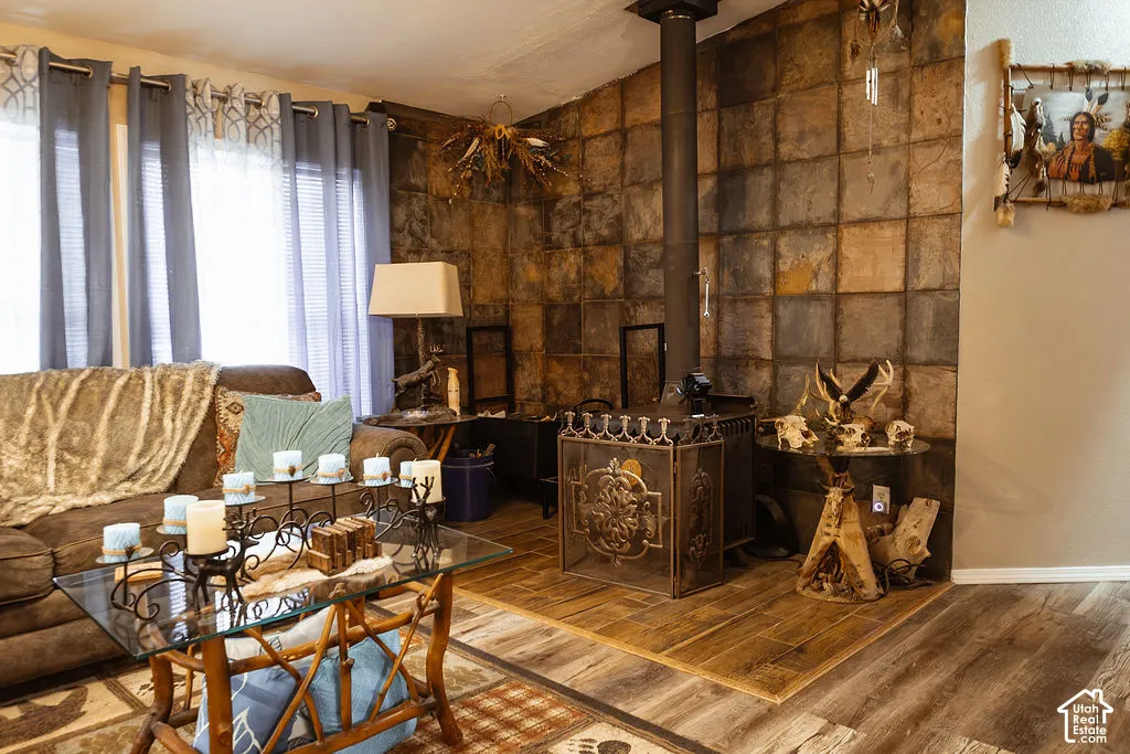 Stone-clad wall with a prominent wood-burning stove featuring an ornate metal screen