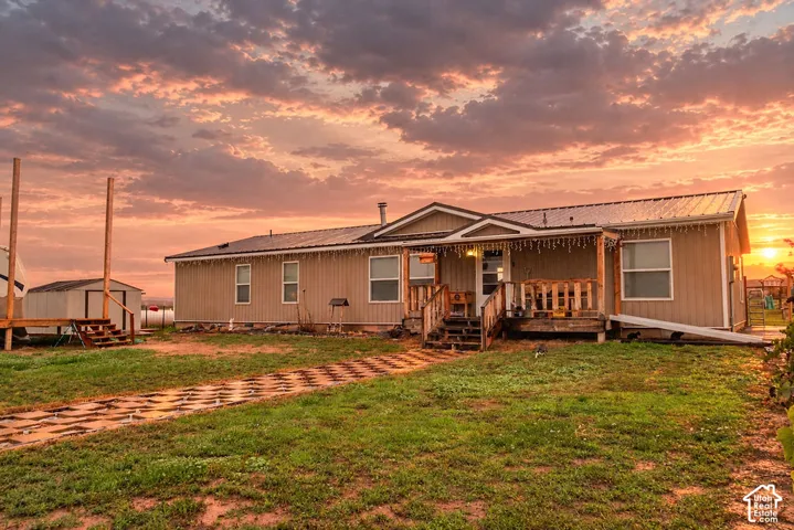 Single-story residence featuring a covered front porch, metal roof, and durable siding