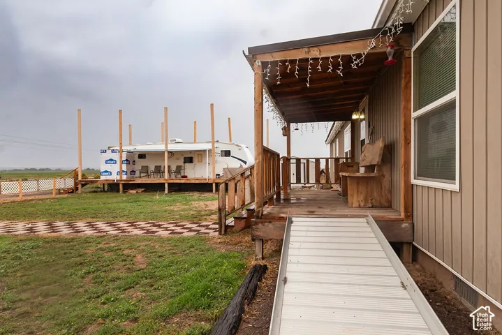 Covered front porch with wood railings and a ramp