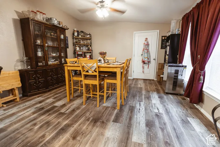 Wood-finish flooring, ceiling-mounted fan with integrated lighting, and a solid-core interior door