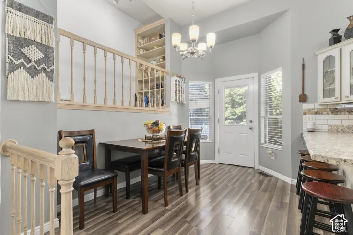Wood-finish flooring, built-in shelving, white paneled bay door, and a built-in bar