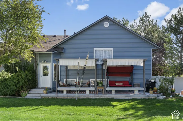 Expansive backyard featuring a manicured lawn, a Trex deck, and two pergola structures