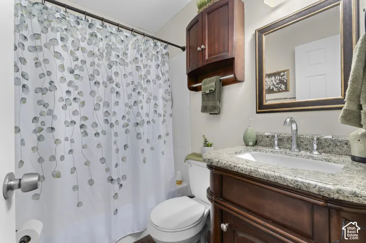 Vanity with integrated sink and wood-finish, wall-mounted wood-finish cabinet, and framed mirror