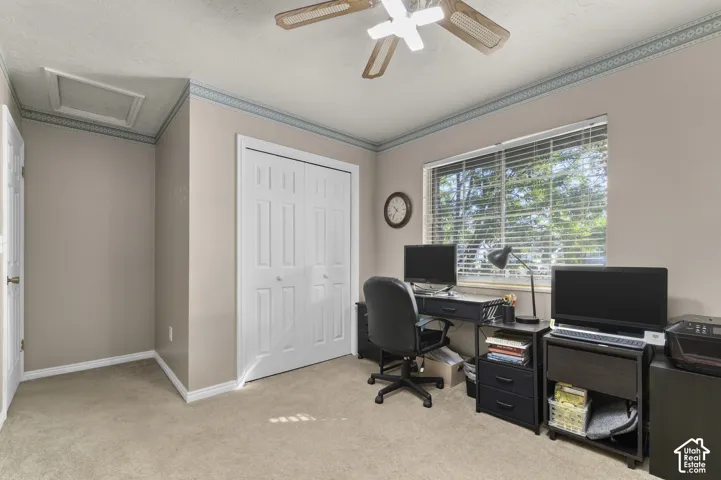 Recessed ceiling access panel, ceiling fan, double-door closet, window with blinds, and neutral wall color