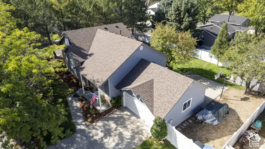 Brand new siding exterior with a brand new shingle roof, attached garage, and concrete driveway
