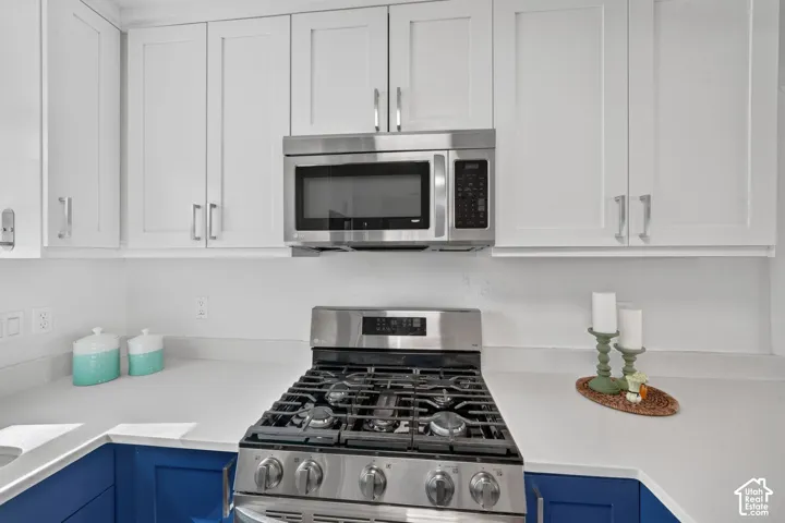 White shaker-style upper cabinetry with brushed nickel hardware