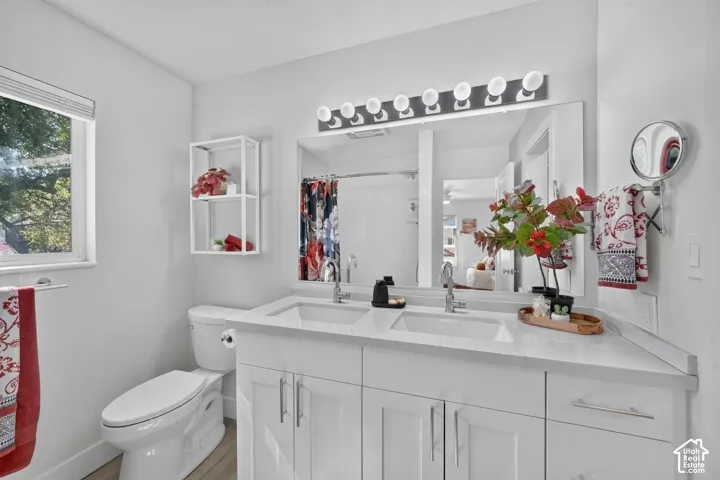 Dual vanity with rectangular undermount sinks, stone countertop, and chrome faucets