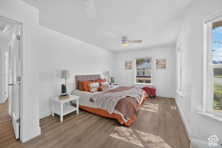 Light wood-finish flooring with white walls